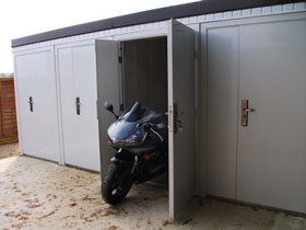 Ministor concrete sheds shown with one motorbike